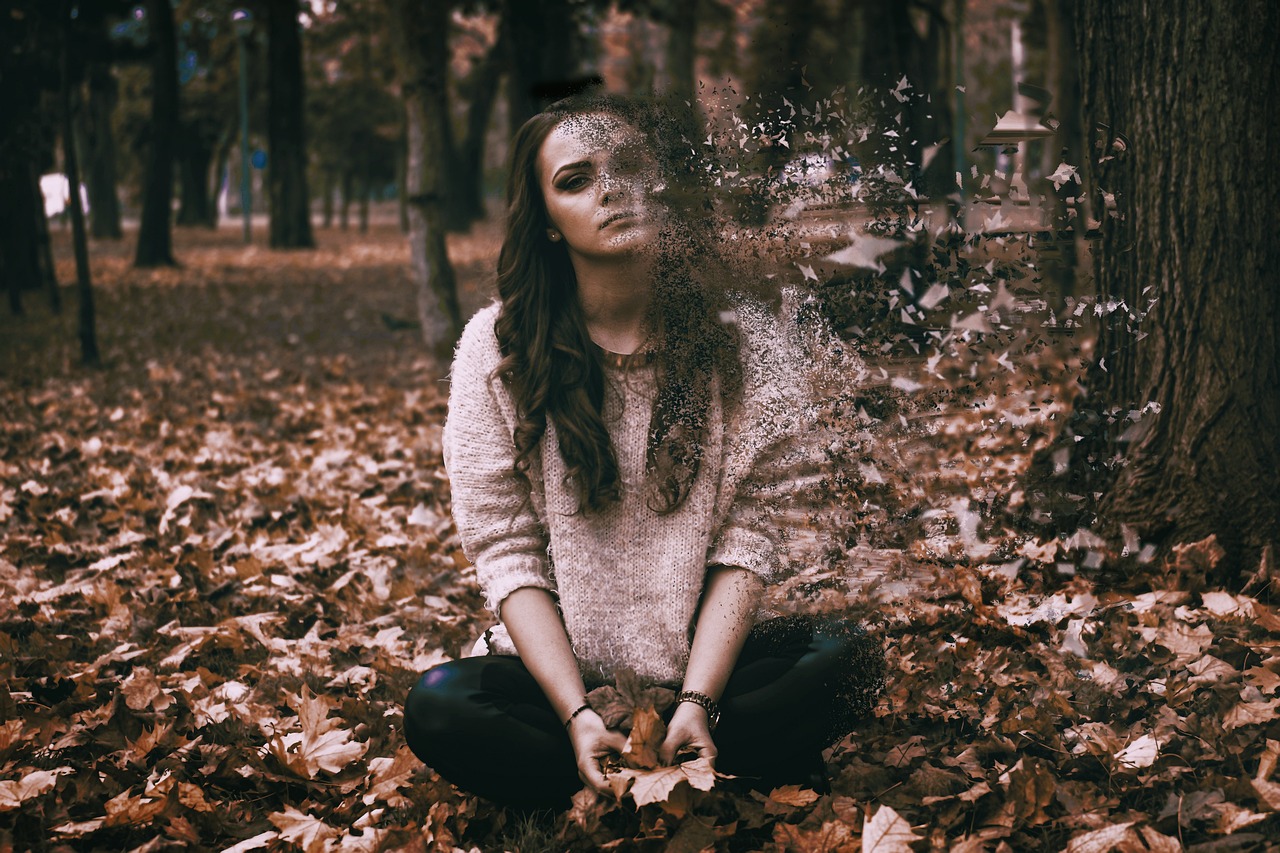Girl Sitting Cross Legged In Park